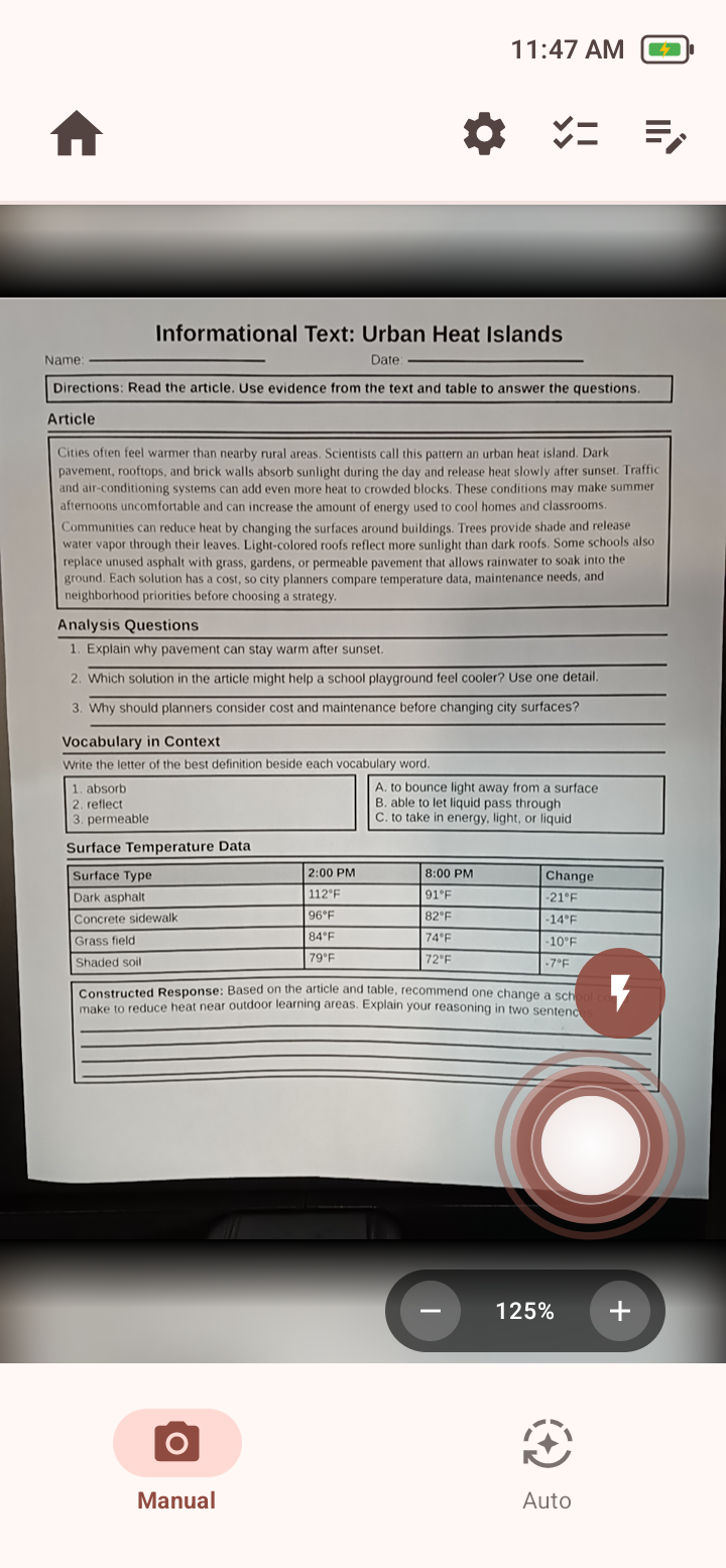 Read camera screen showing a page in the preview, shutter, zoom, flash, Manual, and Auto controls.